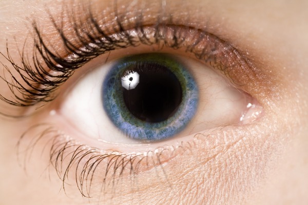 close up of blue eye with highly dilated pupil